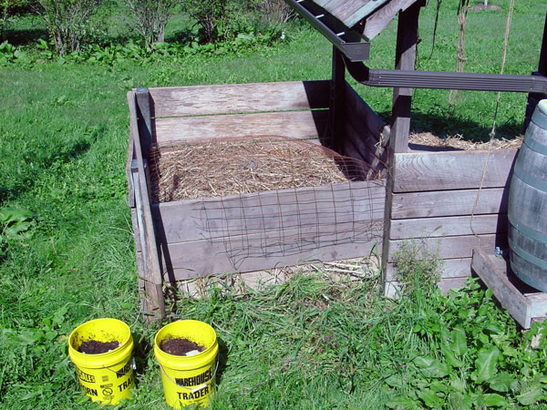 Joe Jenkins Compost Bin humanure about to be emptied into a compost bin